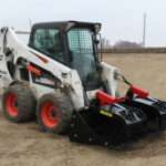 Right angled side view with closed grapples, on skid loader 75 inch Rock Bucket with Grapple by Messer Attachments fits skid loader, wheel loaders, crawl loaders, front loaders. Compatible with John Deere, Bobcat, Case, New Construction, Kubota, JCB