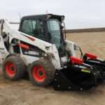 Right angled side view with closed grapples, on skid loader 82 inch Rock Bucket with Grapple by Messer Attachments fits skid loader, wheel loaders, crawl loaders, front loaders. Compatible with John Deere, Bobcat, Case, New Holland, Kubota, JCB