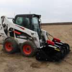 Right angled side view with closed grapples, on skid loader 88 inch Rock Bucket with Grapple by Messer Attachments fits skid loader, wheel loaders, crawl loaders, front loaders. Compatible with John Deere, Bobcat, Case, New Construction, Kubota, JCB